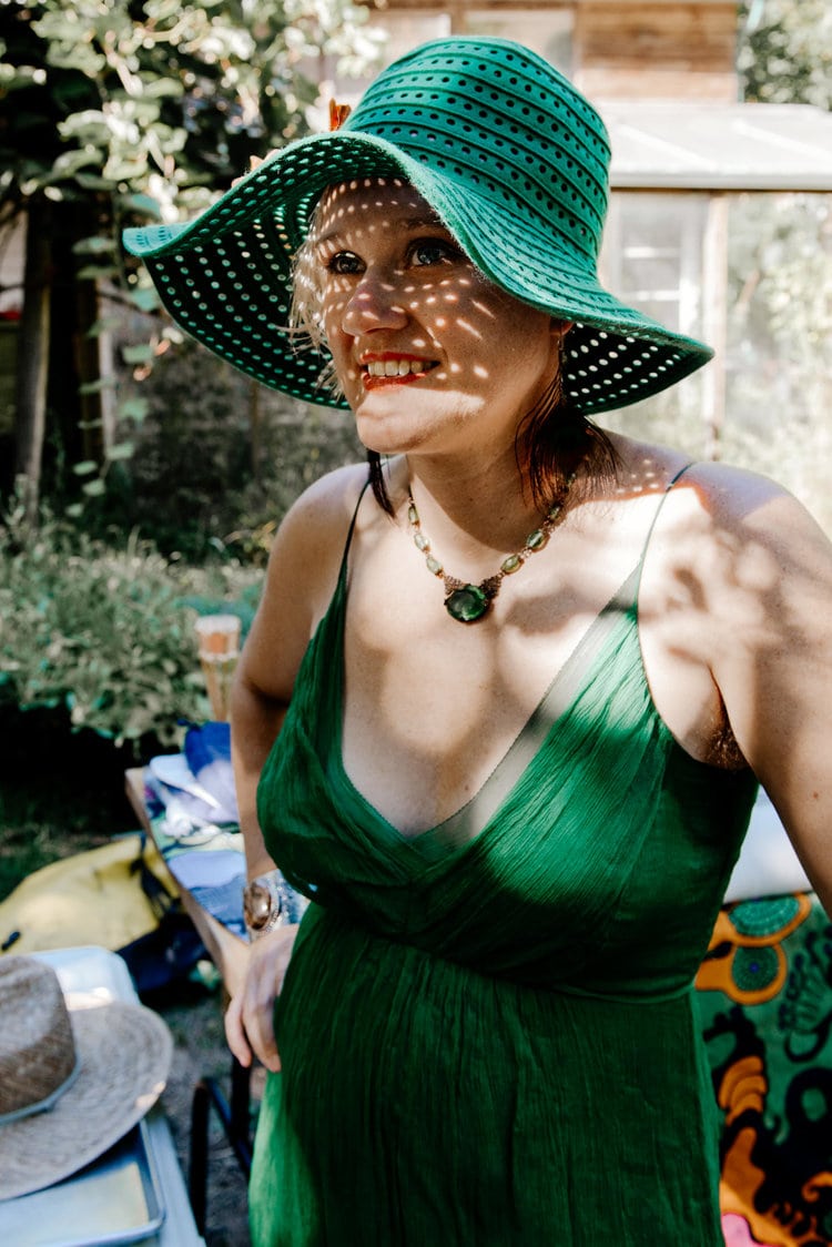 Guest in green sundress and hat