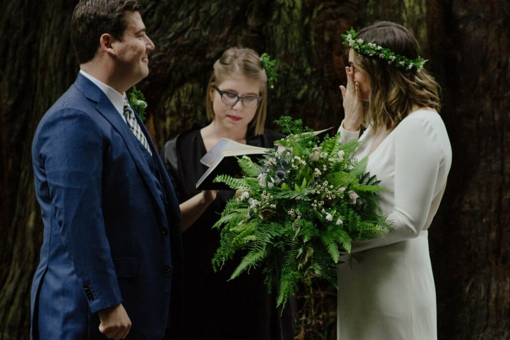 Tearful bride during redwood wedding ceremony