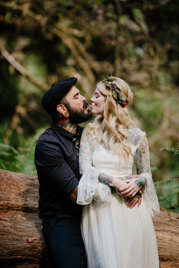 Tattooed couple make faces in the redwoods