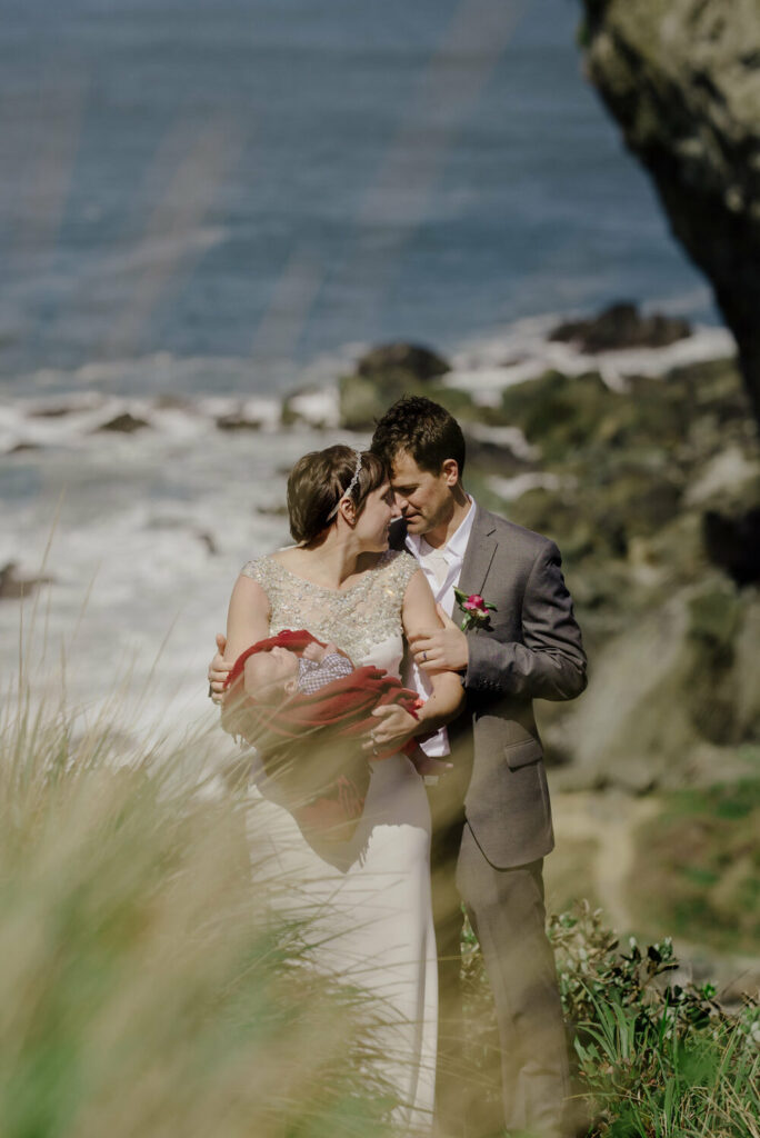 Newlywed couple with infant son on Wedding Rock in Northern California