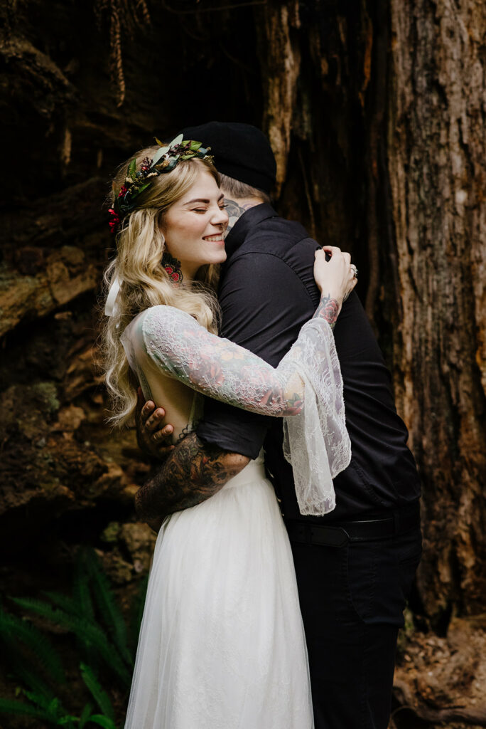 Couple embraces in the redwood forest in Northern California