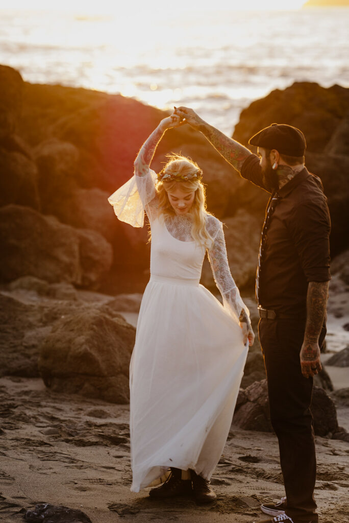 Bride twirls in the golden hour light on Luffenholtz Beach in Northern California