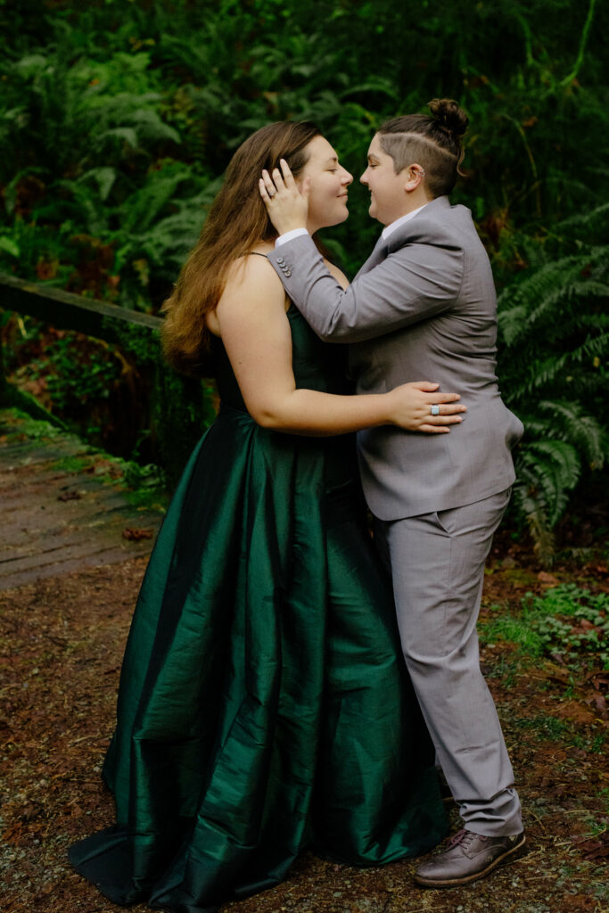 Two brides take a moment during forest engagement session in Northern California