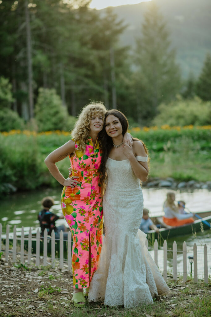 Bride hugs best friend at golden hour on a flower farm in Blue Lake, California