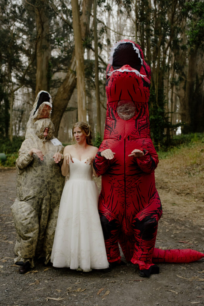 Dinosaur suited guests pose with bride at the Humboldt Bay Social Club Oyster Beach cabins in Samoa, California