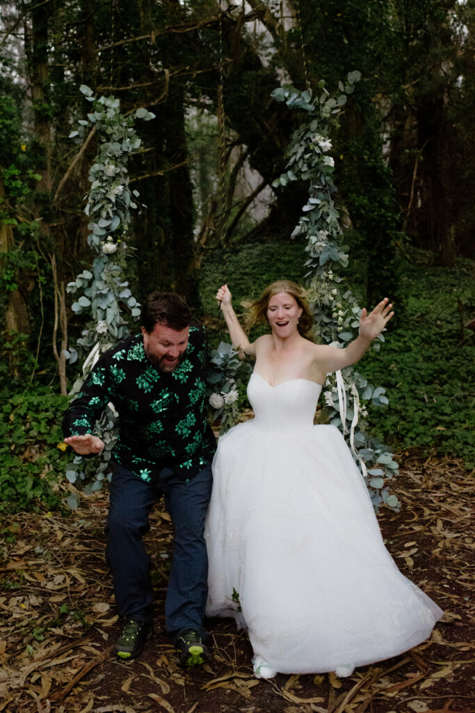 Bride and brother leap from a floral tree swing at the Humboldt Bay Social Club in Northern California