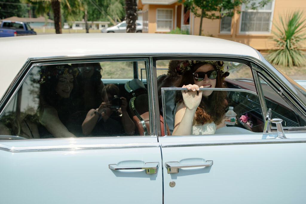 Northern California bride in baby blue vintage car driven by her partner's grandmother