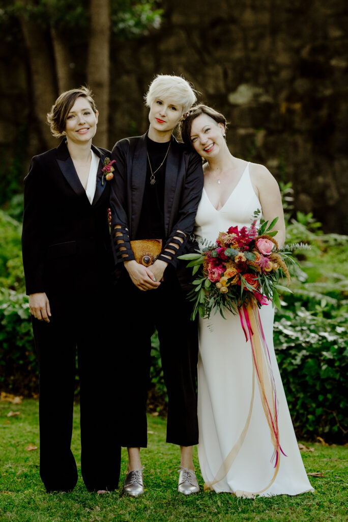 Two brides with officiant following wedding ceremony at the Benbow Inn in Northern California
