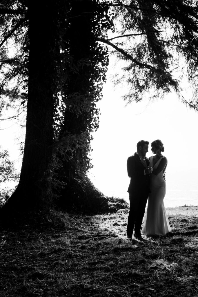 Black and white silhouette portrait of couple during first look in Trinidad, California.