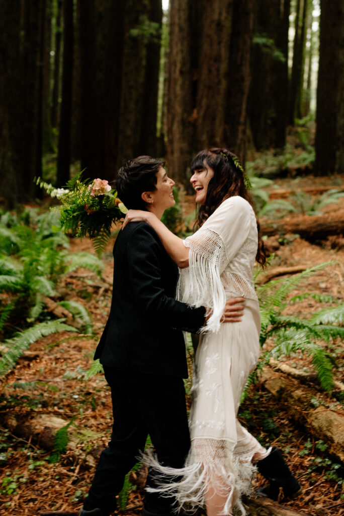 Bride leaps into her partner's arms in Redwood Park in Arcata, California