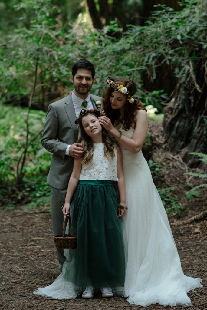 Portrait of wedding couple with their pre-teen daughter in the Pamplin Grove redwoods in Northern California