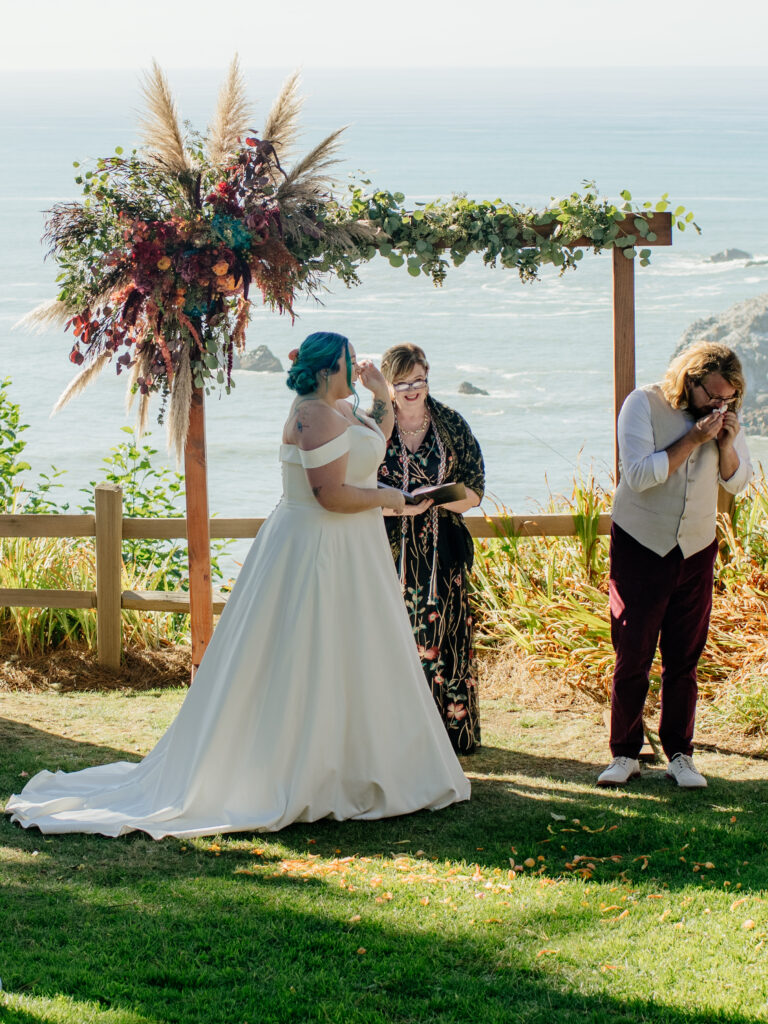 Bride and groom both get tearful before the start of their wedding ceremony overlooking the Pacific Ocean in Northern California