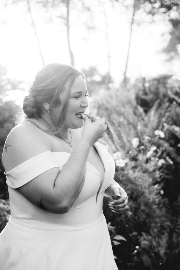 Black and white portrait of a Northern California bride sampling a tiny autumn strawberry at the Lost Whale Inn