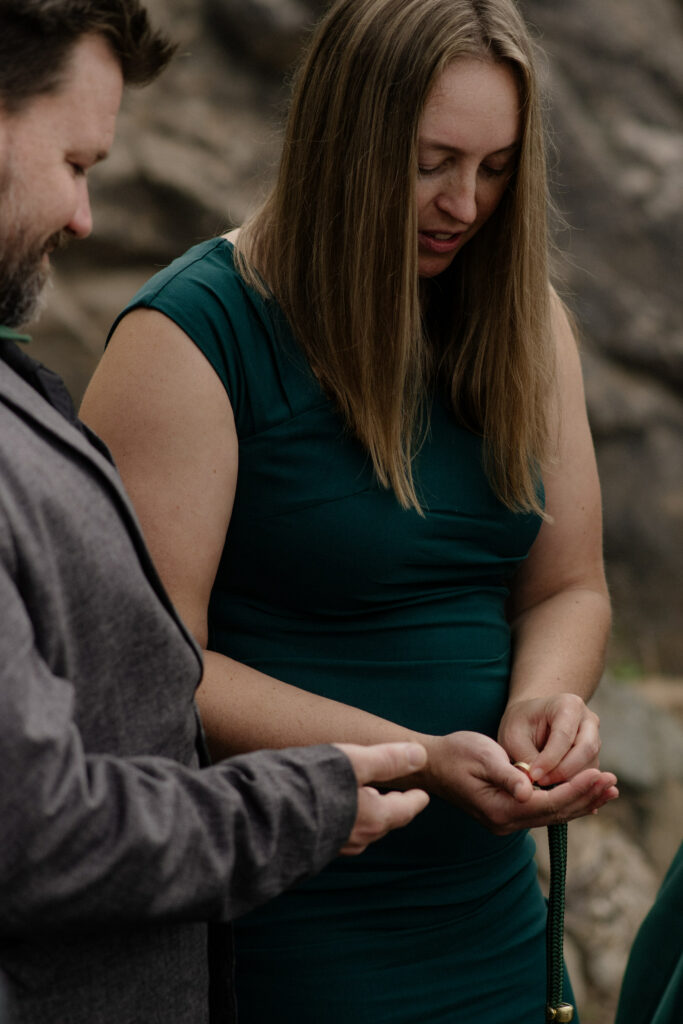 Guest blesses rings before vows at Wedding Rock ceremony
